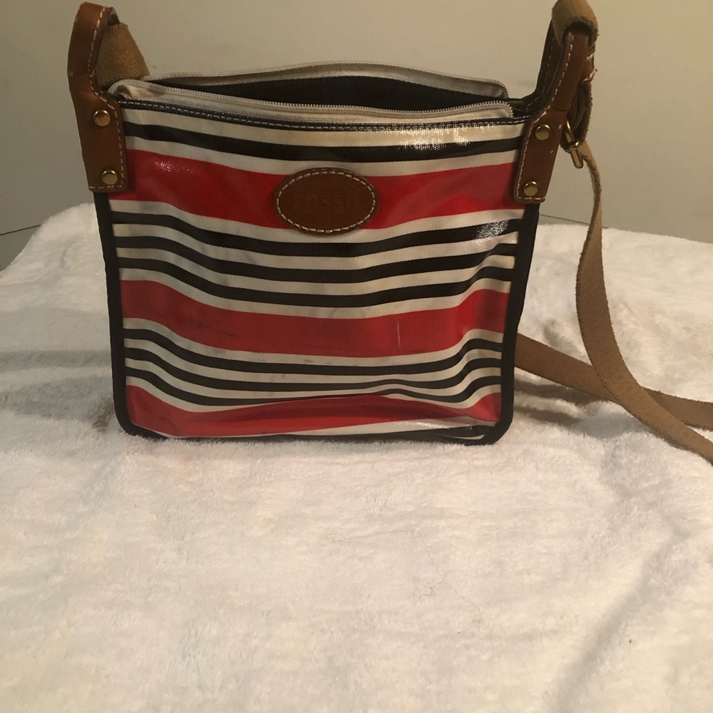 This is a red,white and black fossil cross body bag